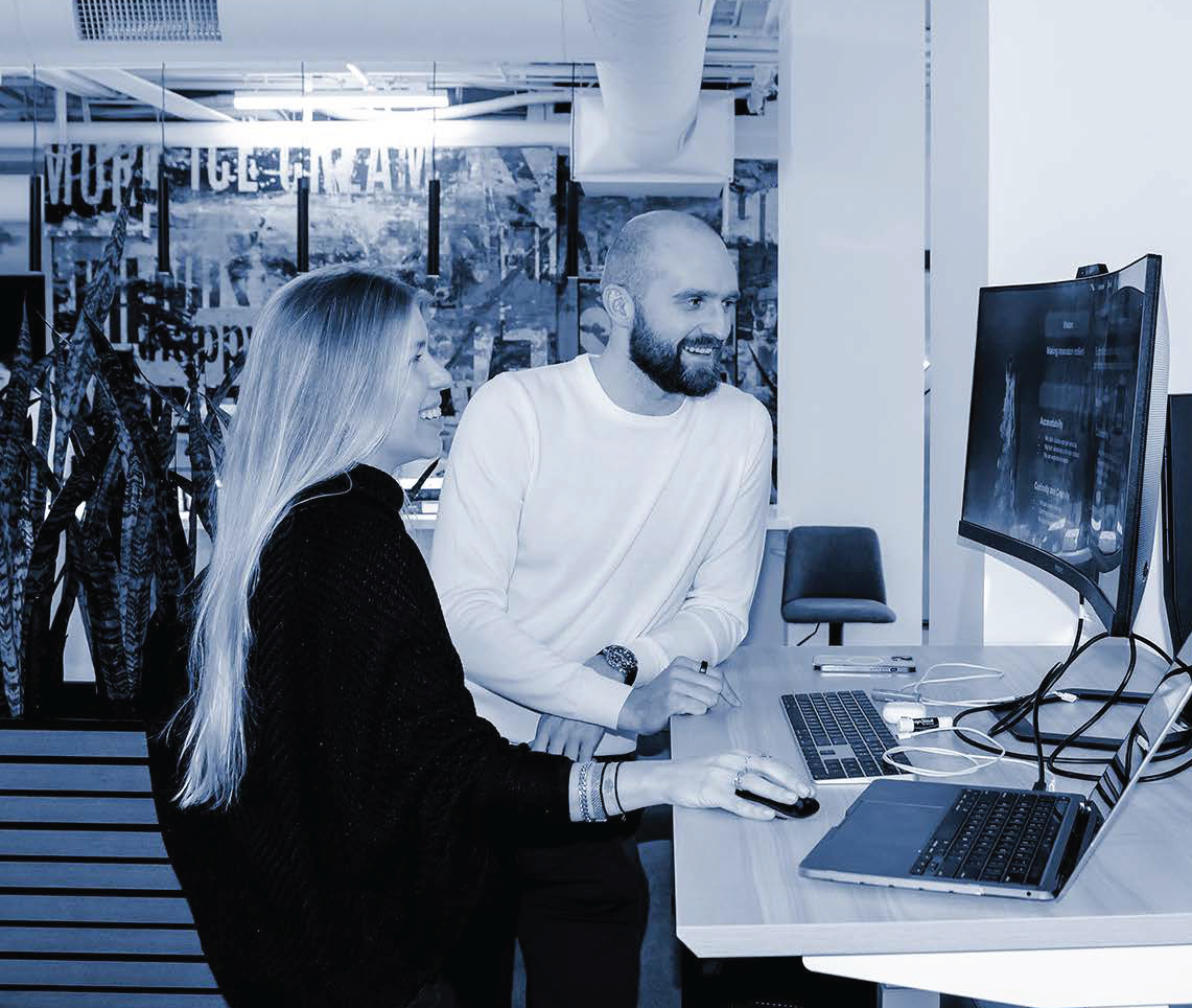 man and woman working at standing desk