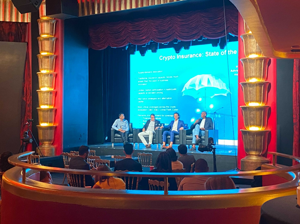 four men on stage at a conference
