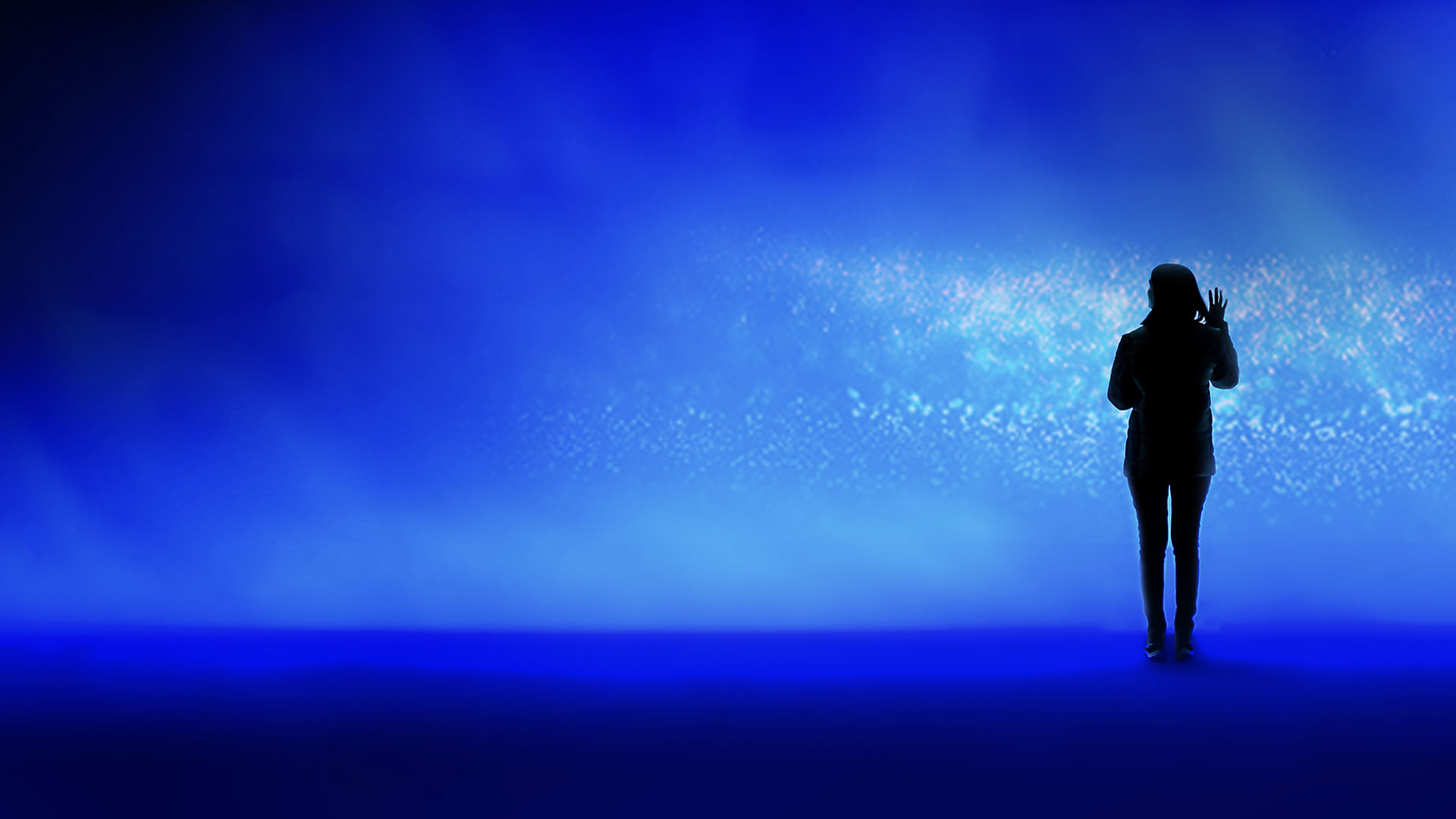 woman reaching out toward lights