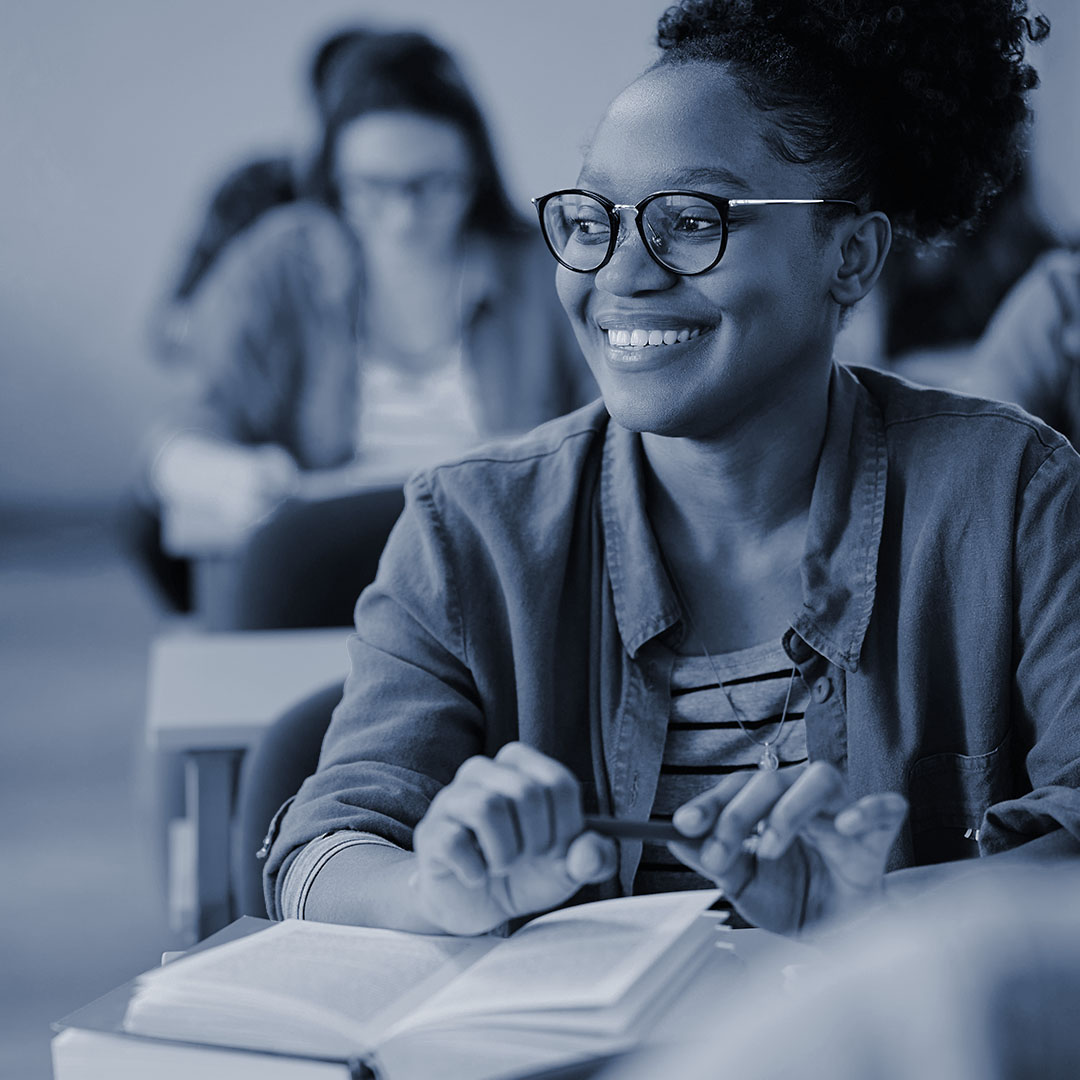 woman smiling in front of a notebook