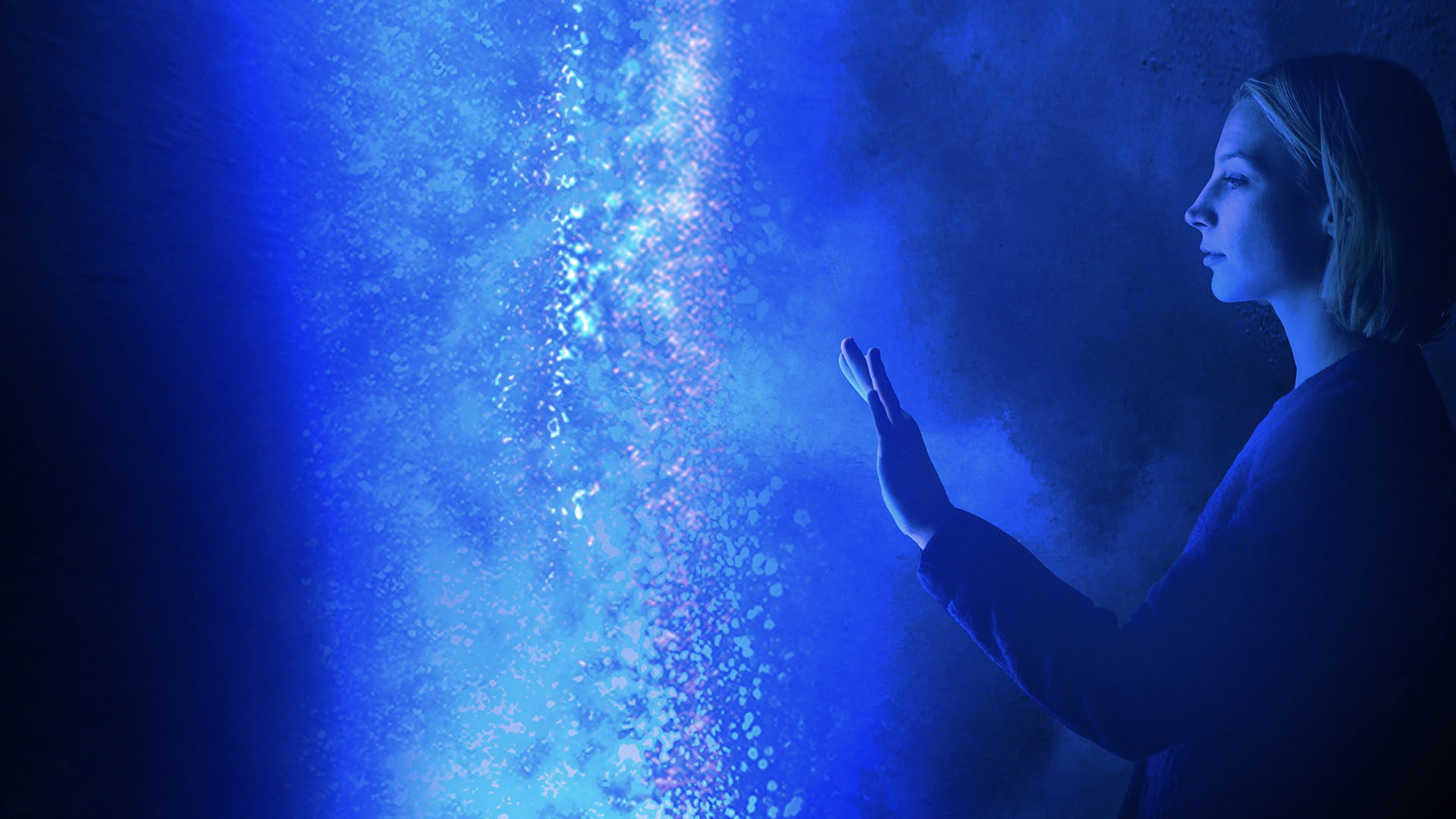 woman reaching out toward lights