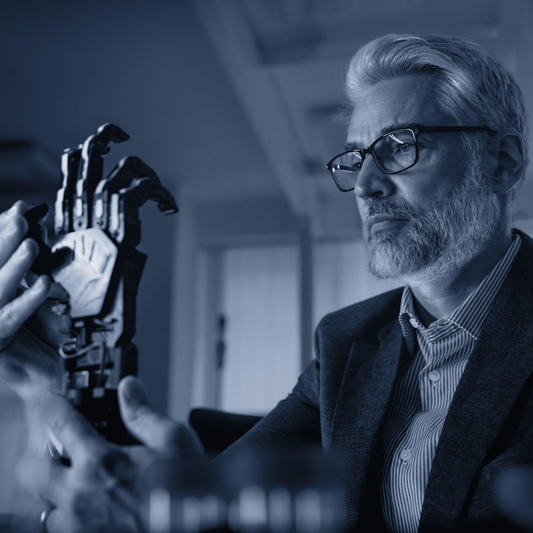 Man studying a robotic hand