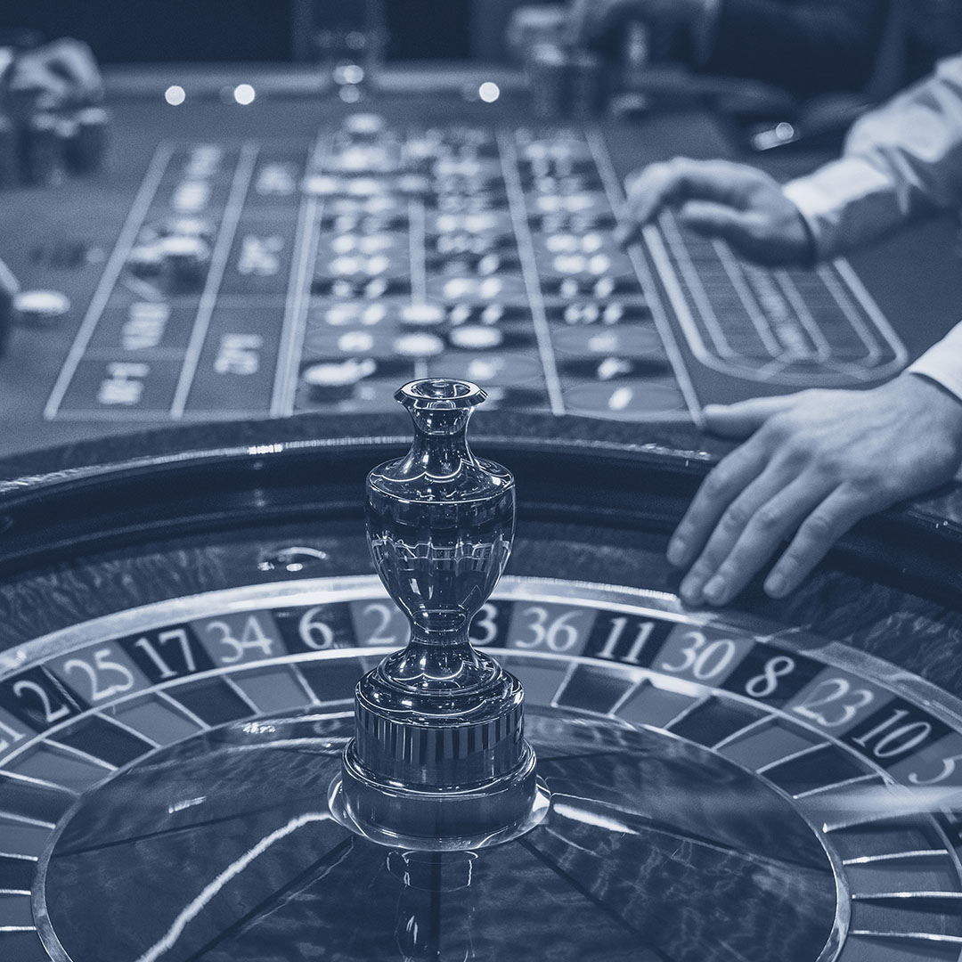 a person spinning a roulette wheel