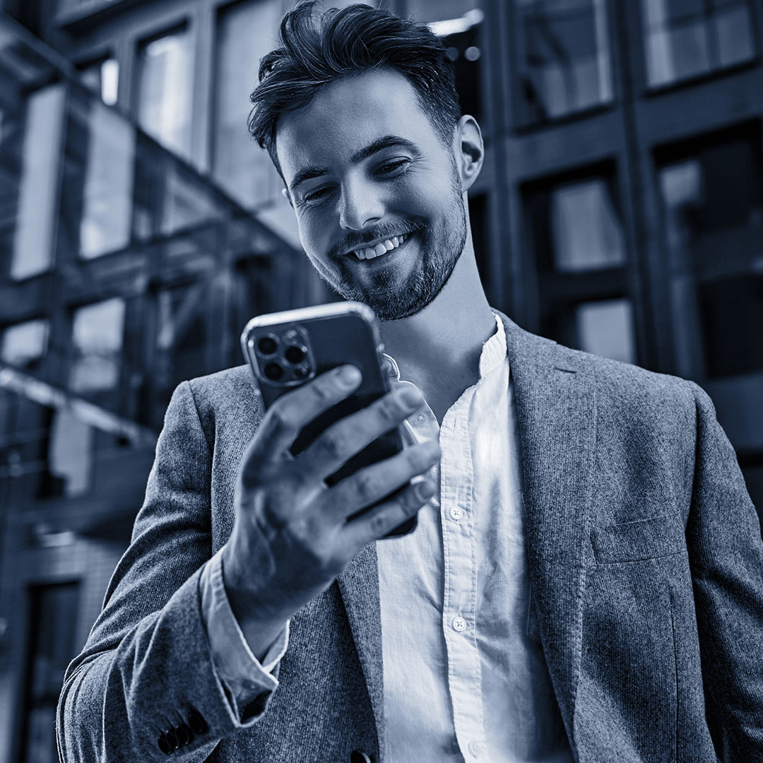 man smiling at mobile phone